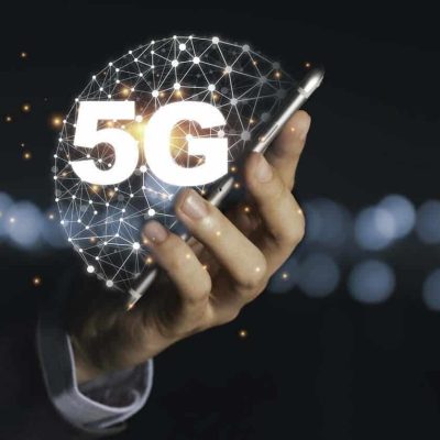 Businessman holding mobile phone with 5G infographic. 5 Generation wireless technology of mobile signal which big change for internet of thing. (Businessman holding mobile phone with 5G infographic. 5 Generation wireless technology of mobile signal wh